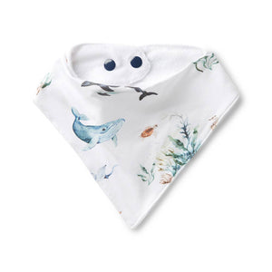 Baby bib with whale and sea plant design on a white background