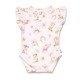 A baby bodysuit in light pink with a western-themed print featuring cowboy boots, pink bows, daisies, horseshoes, and pink slippers. It has ruffled sleeves and snap closures at the crotch and shoulder.