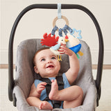 Baby in a car seat with colorful hanging toys