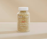 Bottle of Bare Mum Sitz Bath Salts on a beige background