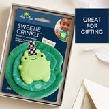 Green silicone sensory teether with packaging on a white surface
