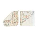 A two-piece baby textile set featuring a floral print, including a square muslin cloth with a tassel and a matching square muslin wrap, both displayed on a clean white background.