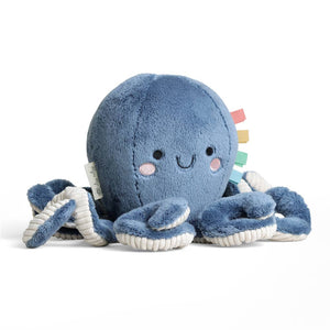 Blue plush octopus toy with a smiling face on a white background