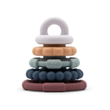 Stack of colorful baby teething rings on a white background