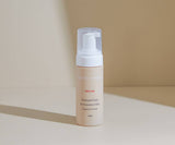 Skincare bottle with pump on a beige background