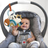 Baby in a car seat with a colorful toy hanging from the headrest