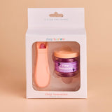 Product packaging with a jar labeled 'tiny tummies' and a pink tool on a beige background.