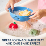 Child playing with bath toys in a bathtub, including a blue net and colorful rubber duckies.