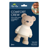 Packaging of a teddy bear-shaped comfort crew teether with a child holding a similar product on the side.
