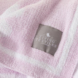 Close-up of a pink textured fabric with a 'Living Textiles Australia' label.