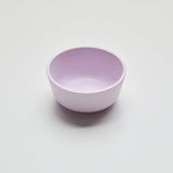 Purple ceramic bowl on a light gray background