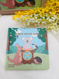 Children's book titled 'A Day with Kiki' by Onya Kids on a white surface with flowers in the background.