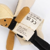 Close-up of a plush toy with a label on a white background