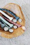Colorful beaded necklaces on a wooden surface