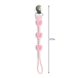 Pink pacifier clip with heart designs and measurement label on a white background