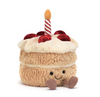 Plush toy cake with a candle on a white background