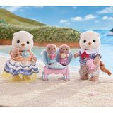 Toy figurines of a family on a beach with a scenic background