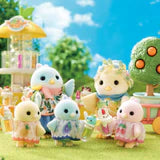 Colorful toy figures of animals in a garden setting with trees and a blue sky.