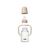 BIBS baby bottle with wooden cap and handle on a white background