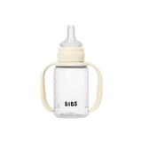 Clear baby bottle with beige accents and 'Bibs' branding on a white background