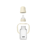 Clear baby bottle with white cap and handle on a white background, featuring the 'Bibs' brand.