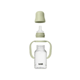 Clear baby bottle with green lid and handle on a white background