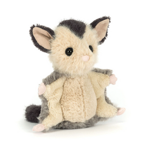 Plush toy possum on a white background