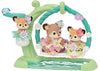 Toy figurines of three animals on a swing set with flowers and butterflies.