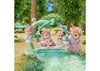 Toy figurines of bears with flowers in a garden setting