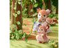 Two toy deer figures in a garden setting with flowers and trees.